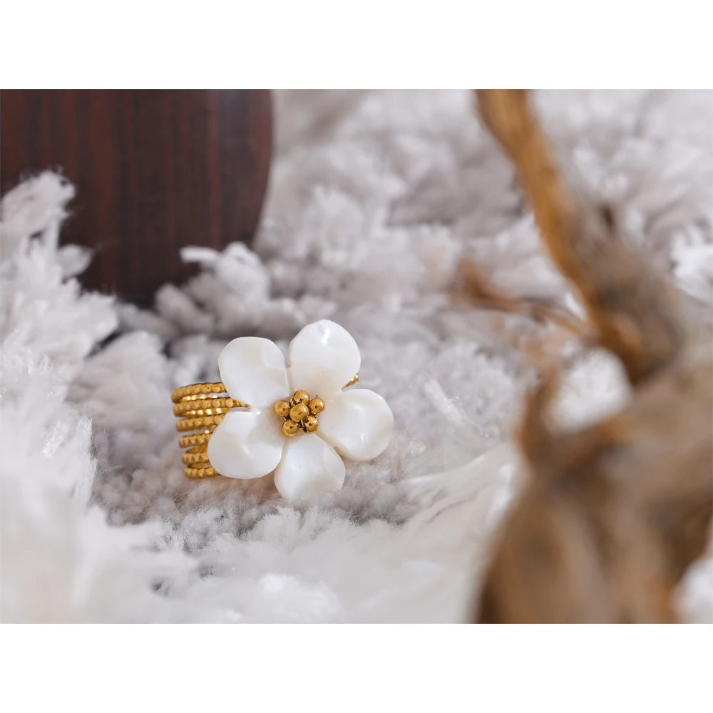 Open ring decorated with a natural shell flower 