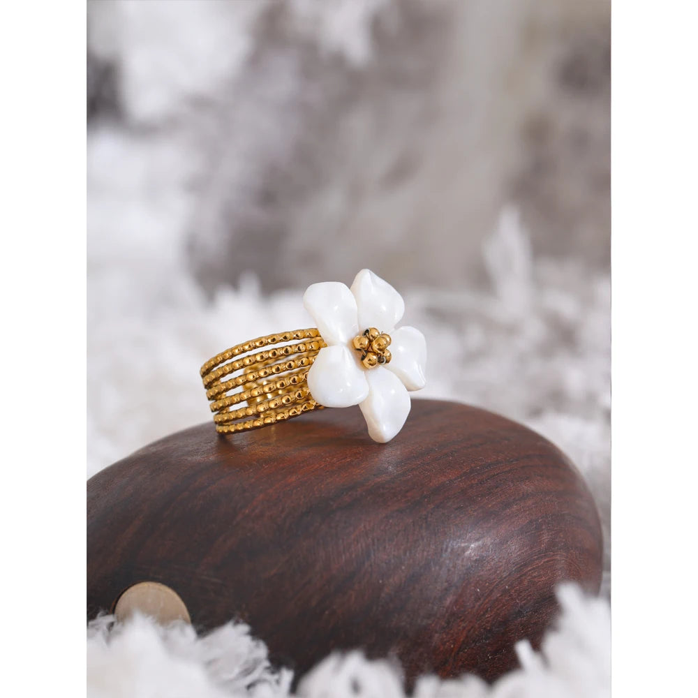 Open ring decorated with a natural shell flower 